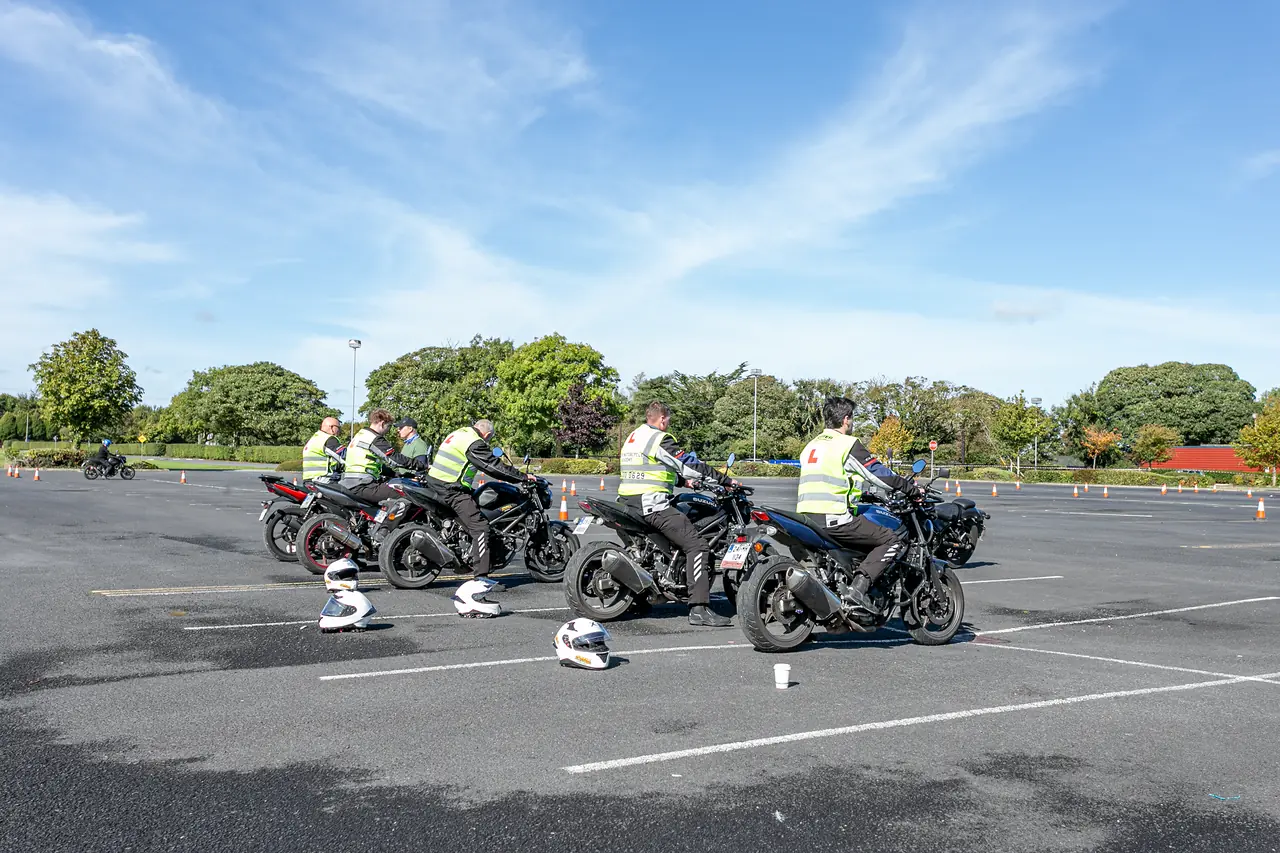 Learner riders in hi-vis L-plate vests lined up on motorcycles on the training yard at Fairyhouse Racecourse, Ratoath