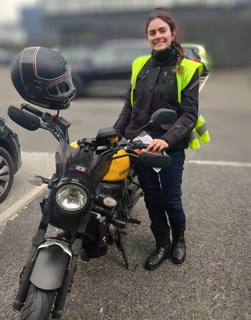 A Meath Motorcycle Academy learner in a hi-vis vest beside a Yamaha at training